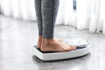 A person measuring weight
